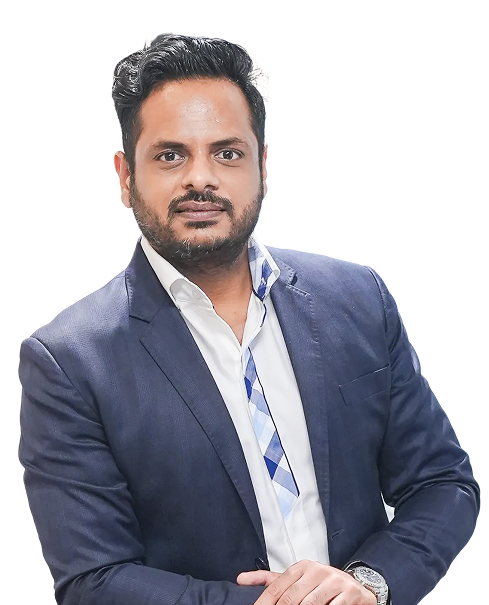 Professional portrait of a man in a navy blazer and white shirt, looking at the camera with hands resting on a surface.