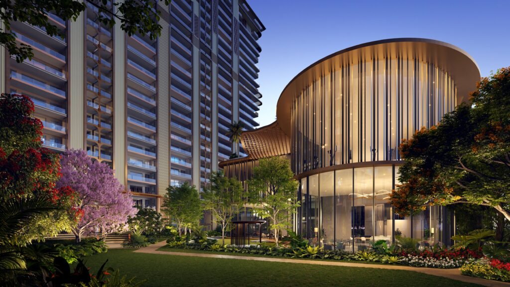 Modern architectural complex with a curved glass facade surrounded by lush landscaping at dusk.