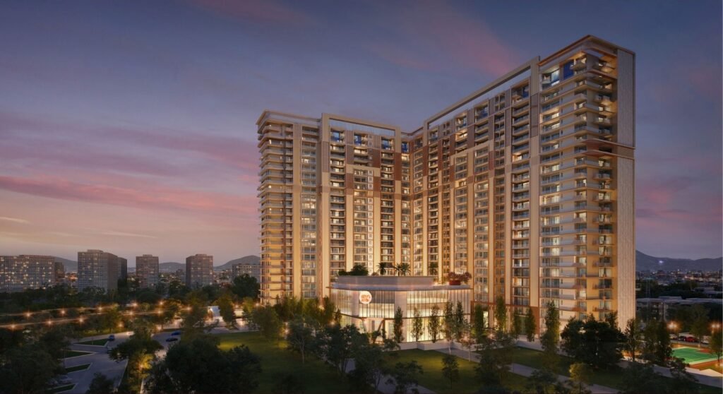 Sunset view of a large modern apartment complex with numerous balconies and a surrounding park.